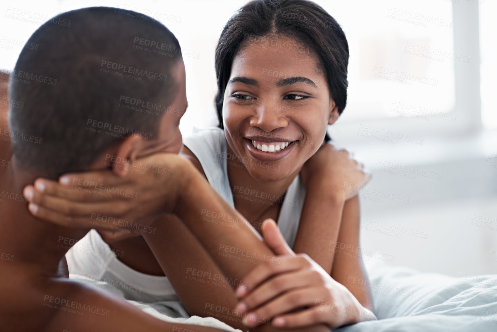 Buy stock photo Smile, relax and woman on bed in house with bonding, love and conversation in marriage on holiday. Happy, talking and couple in bedroom for relationship connection, care and weekend break in home.