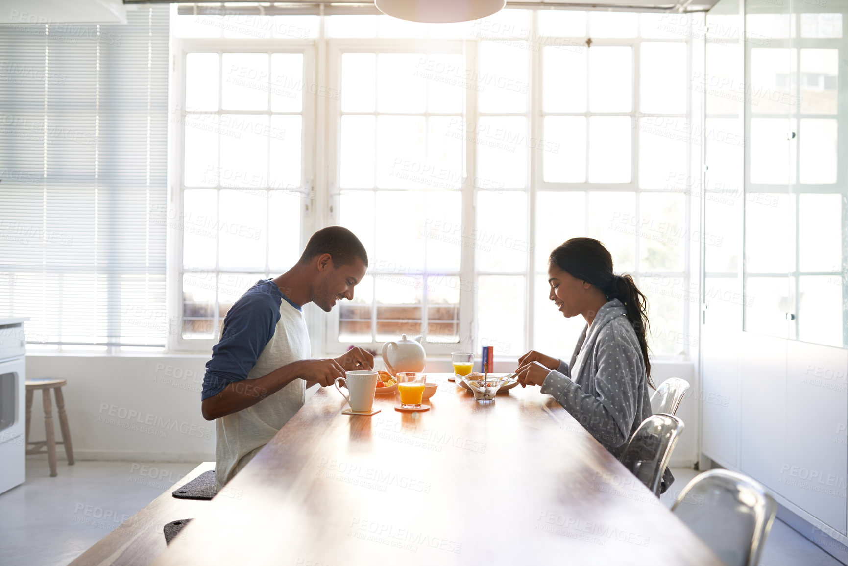 Buy stock photo Eating, breakfast and couple in house for date, bonding or connection in marriage for anniversary. Juice, food and happy people with morning meal together for relationship celebration in apartment.