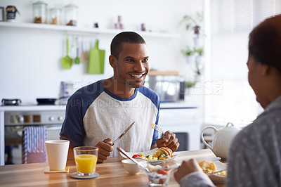 Buy stock photo Cropped shot of a young couple having breakfast in the kitchen