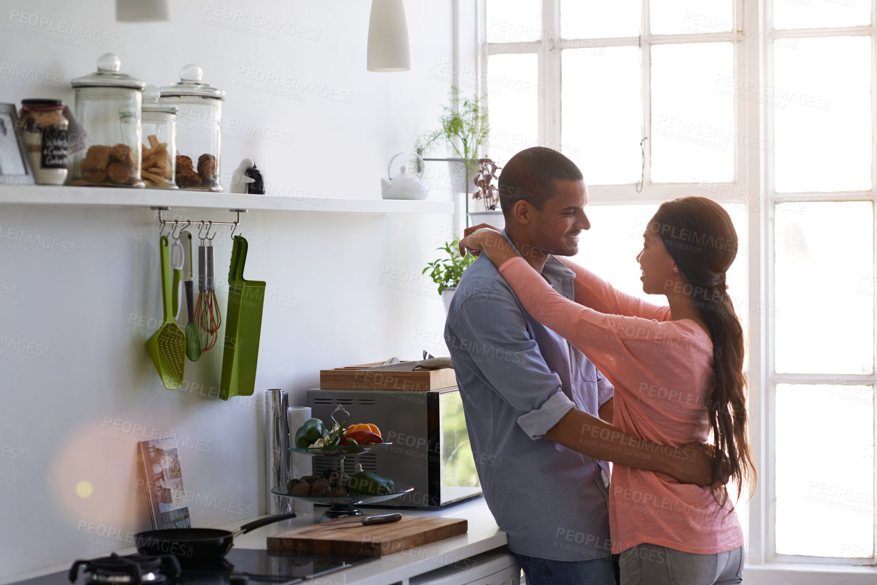 Buy stock photo Hug, smile and couple with trust in home, relationship security and love with safety together. Kitchen, happy man and woman embrace for connection, bonding or care with partner commitment for support
