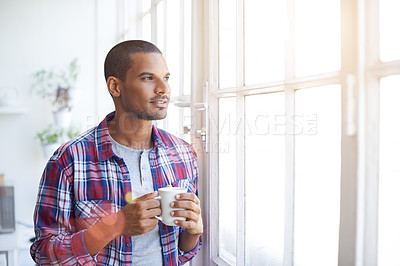 Buy stock photo Cropped shot of a young man looking out of the kitchen window