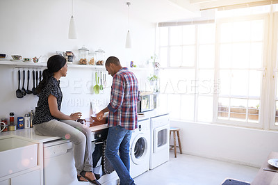 Buy stock photo Shot of a young couple preparing dinner in their kitchen