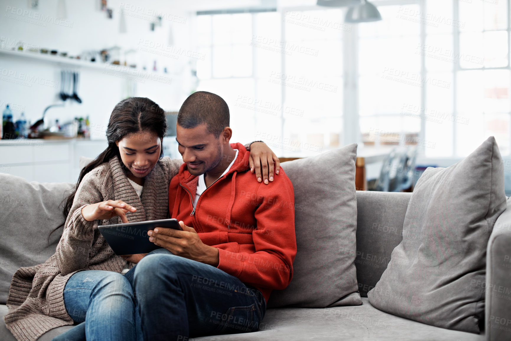 Buy stock photo Hug, tablet and happy couple on sofa with care, vacation booking or destination decision on weekend. Technology, man and woman in home to relax, holiday planning or embrace for love with partner