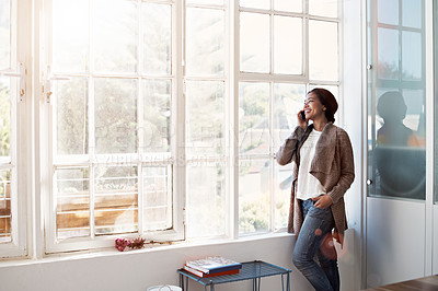 Buy stock photo Cropped shot of a young woman using her cellphone in the kitchen