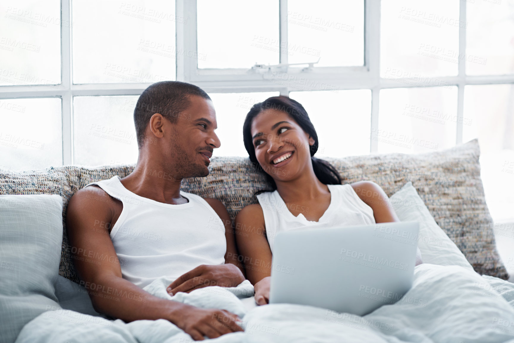 Buy stock photo Chill, happy or couple in bedroom with laptop, movie streaming or connection on weekend break. Relax, digital or people in home with day off, bonding moment or show subscription on entertainment site