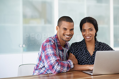 Buy stock photo Portrait of a young couple sitting at their dining table using a latpop