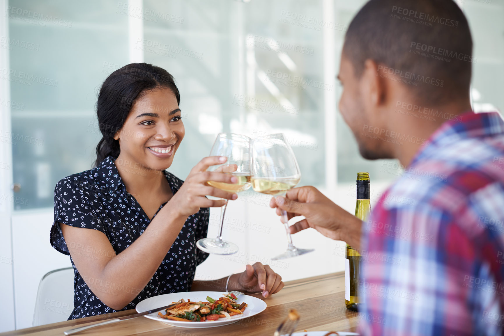 Buy stock photo Couple, toast or wine with smile at dinner, meal together or anniversary celebration in home. Happy woman, man and drink cheers for relationship milestone, food and bonding for love, care and romance
