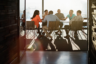 Buy stock photo Shot of a group of colleagues having a meeting together in a boardroom