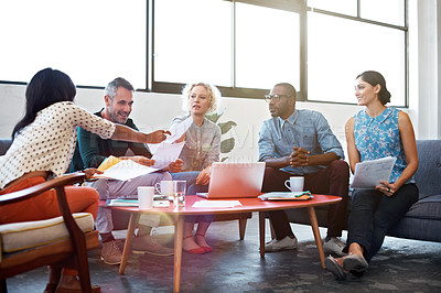 Buy stock photo Shot of a group of coworkers talking together in a modern office