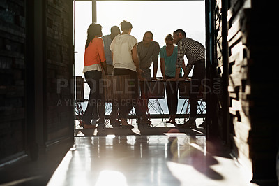 Buy stock photo Shot of a group of businesspeople standing around a table in the boardroom