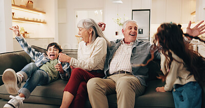 Buy stock photo Excited, playing and grandparents with children on sofa for bonding, love and connection for home visit. Family, generations and kids with senior people for relationship, energy and relax on weekend