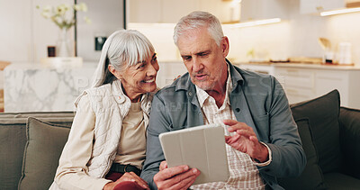 Buy stock photo Smile, old couple and reading in home with tablet, social media or browsing for online shopping. Happy, senior people and relax on sofa with digital, internet search and explain catalog for ecommerce
