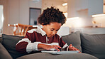 Child, relax and browsing in home with tablet, kids website or learning how to play knowledge game. African boy, scroll and chill in living room with tech, online educational gaming or entertainment.