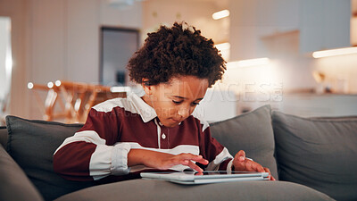Buy stock photo Child, relax and browsing in home with tablet, kids website or learning how to play knowledge game. African boy, scroll and chill in living room with tech, online educational gaming or entertainment.