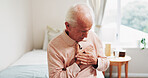 Senior, man and bed with chest pain for cardiac arrest, heart attack or discomfort in home. Elderly, male person or tension with ache for chronic stress, disease or hypertension in bedroom or house