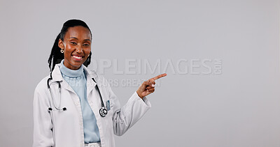 Buy stock photo Pointing, space and portrait of doctor in studio for medical service, health support and mockup. Healthcare, happy and black woman with announcement for medicare, wellness or news on white background