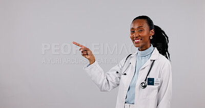 Buy stock photo Pointing, studio and portrait of African doctor for medical service, advertising and health mockup. Healthcare, happy and woman with info space for medicare, wellness and news on white background