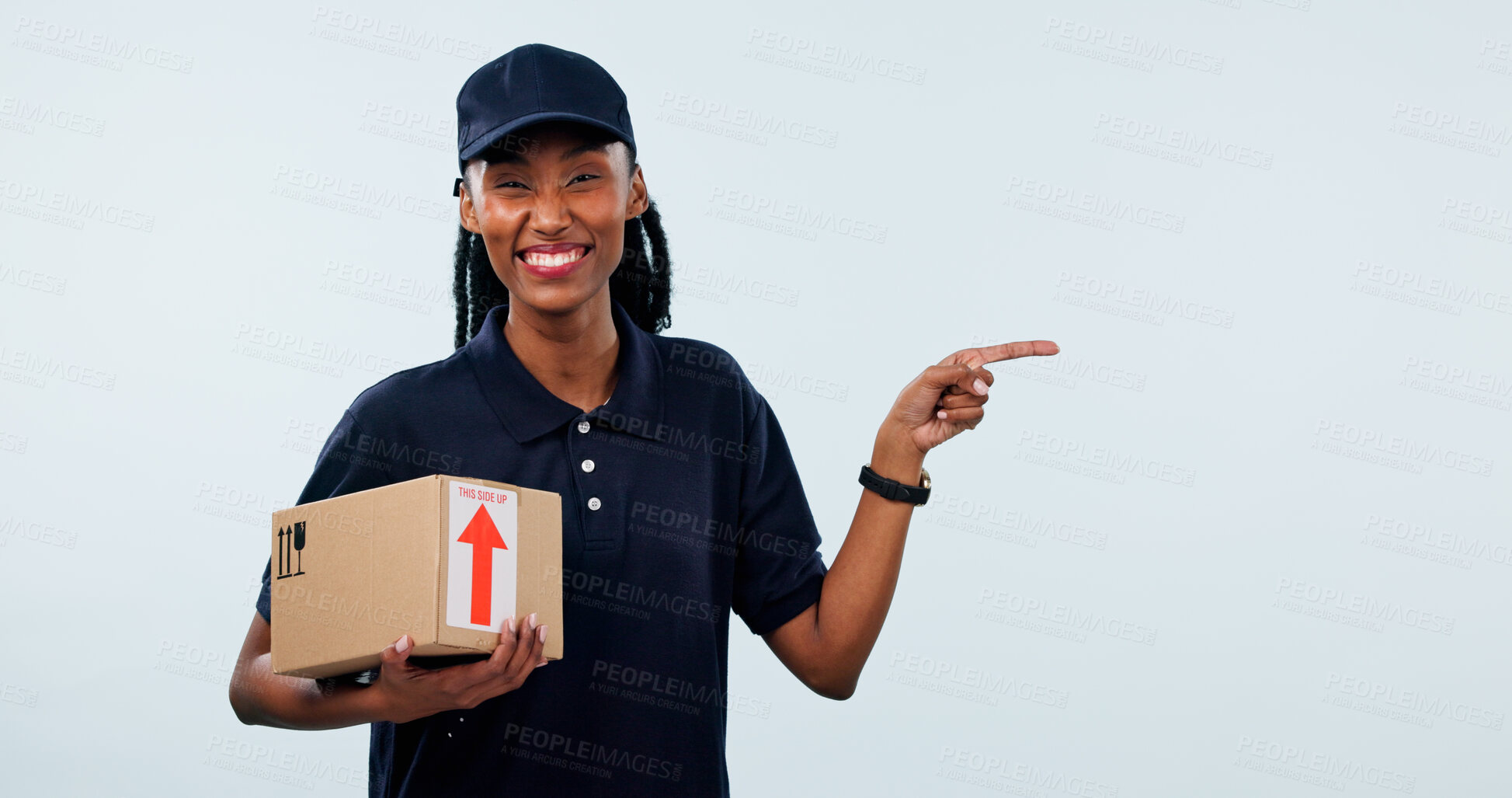 Buy stock photo Pointing, portrait and woman in studio for delivery, shipping and info space for courier service. Mockup, happy and African person with box for ecommerce, logistics or advertising on white background
