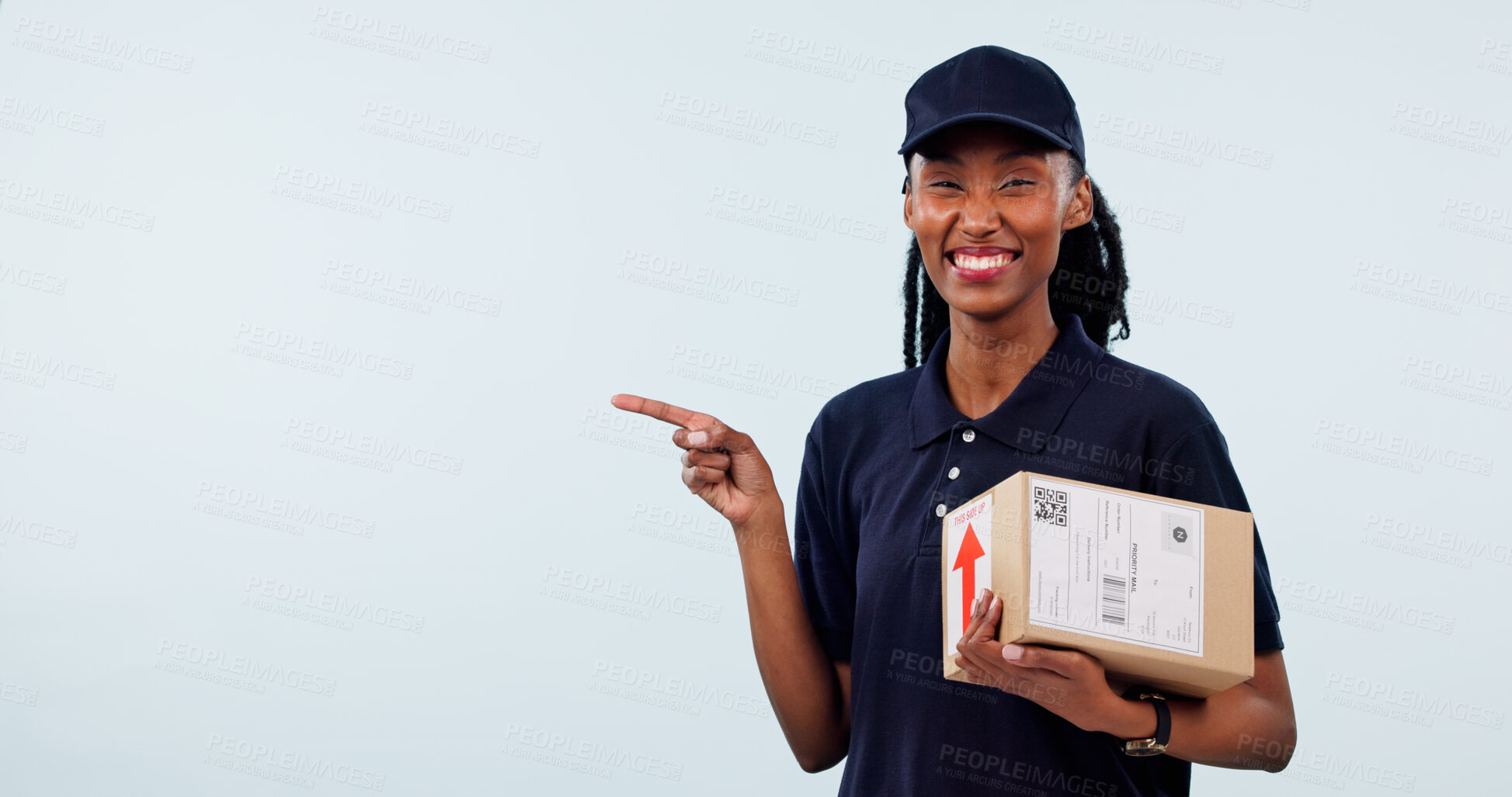 Buy stock photo Pointing, delivery and portrait of woman with space for shipping, courier service and ecommerce info. Mockup, happy and black person with box for supply chain, logistics and news on studio background