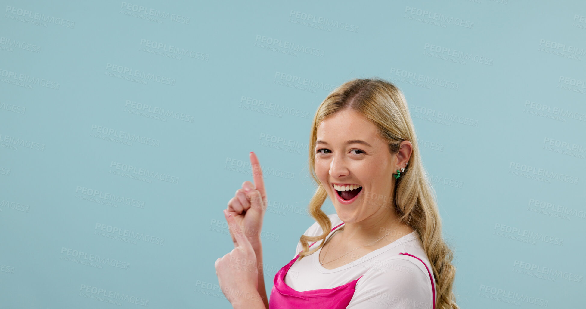 Buy stock photo Excited, pointing and fashion with portrait of woman in studio for announcement, retail news and space. Sale promotion, style advertising and happy with female person on blue background for mockup