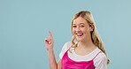 Mockup, pointing and fashion with portrait of woman in studio for announcement, retail news and space. Sale promotion, style advertising and happy with female person on blue background for offer