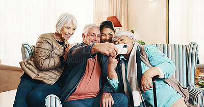 Buy stock photo Caregiver, home and selfie with friends in retirement, smile and capture moment for social media. Happy carer, senior people and picture in living room with laugh, photography and memory in homecare