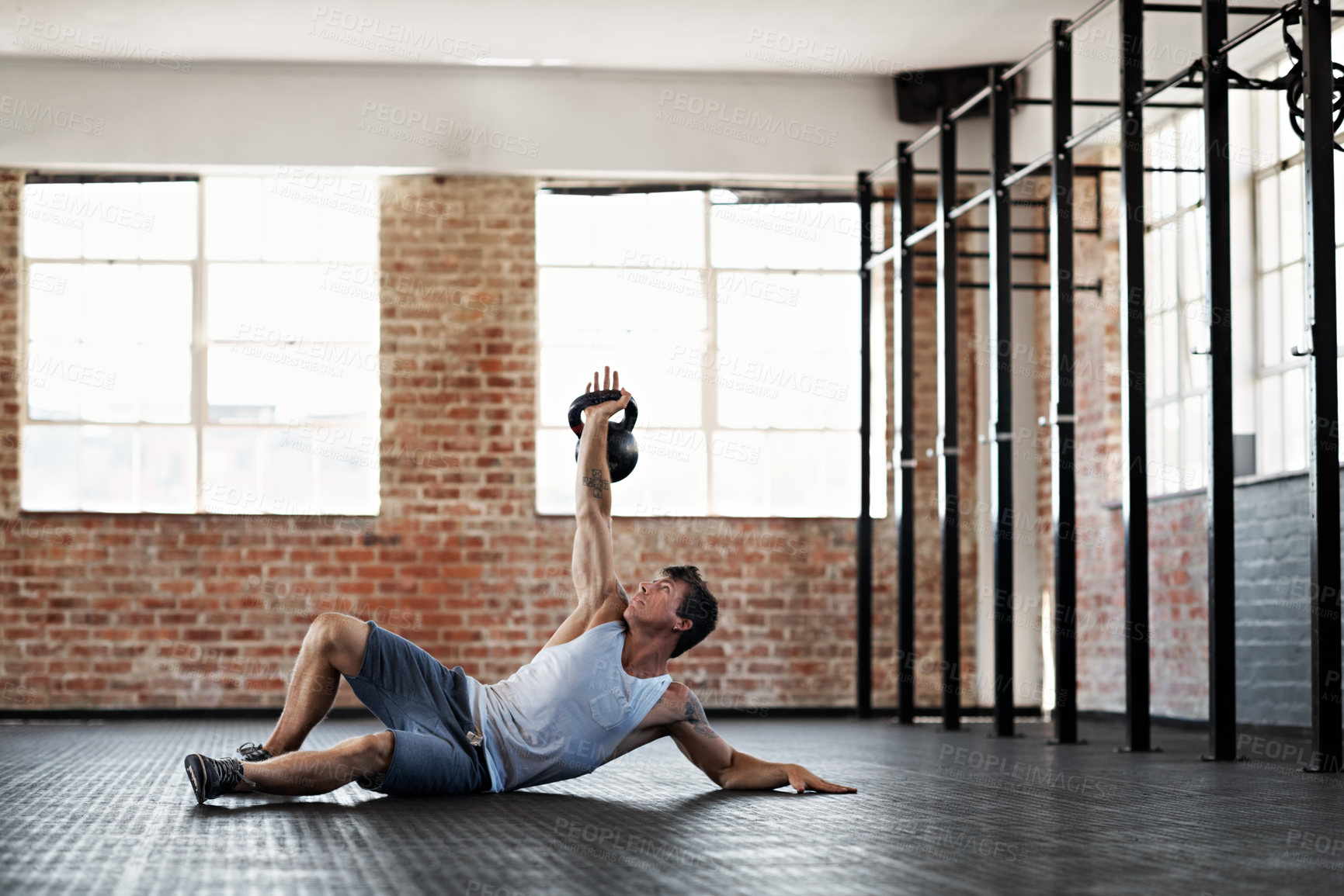 Buy stock photo Fitness, man and kettlebell exercise in gym with training, challenge or strength for weightlifting. Bodybuilder, person or endurance workout at sports center with muscle, performance or core health