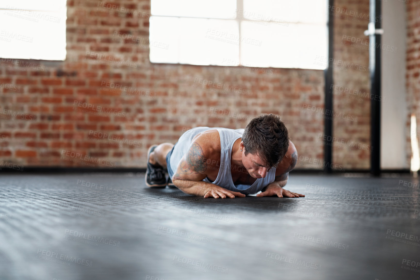 Buy stock photo Man, fitness and exercise with push up in gym for indoor workout, muscle gain or training. Active, male person or lifting body weight with arms for strength, wellness or power on floor in health club