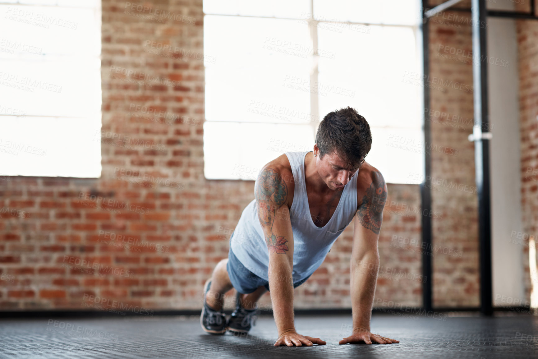 Buy stock photo Man, fitness and exercise with push up on floor for indoor workout, muscle gain or training in gym. Active, male person or lifting body weight with arms for strength, wellness or power in health club