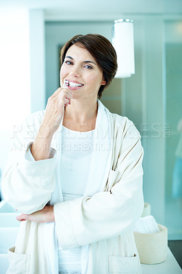 Buy stock photo Portrait, woman and brushing teeth in bathroom with morning routine, dental hygiene and wellness. Happy, person and getting ready in house with bathrobe, toothbrush and oral health for fresh breath.