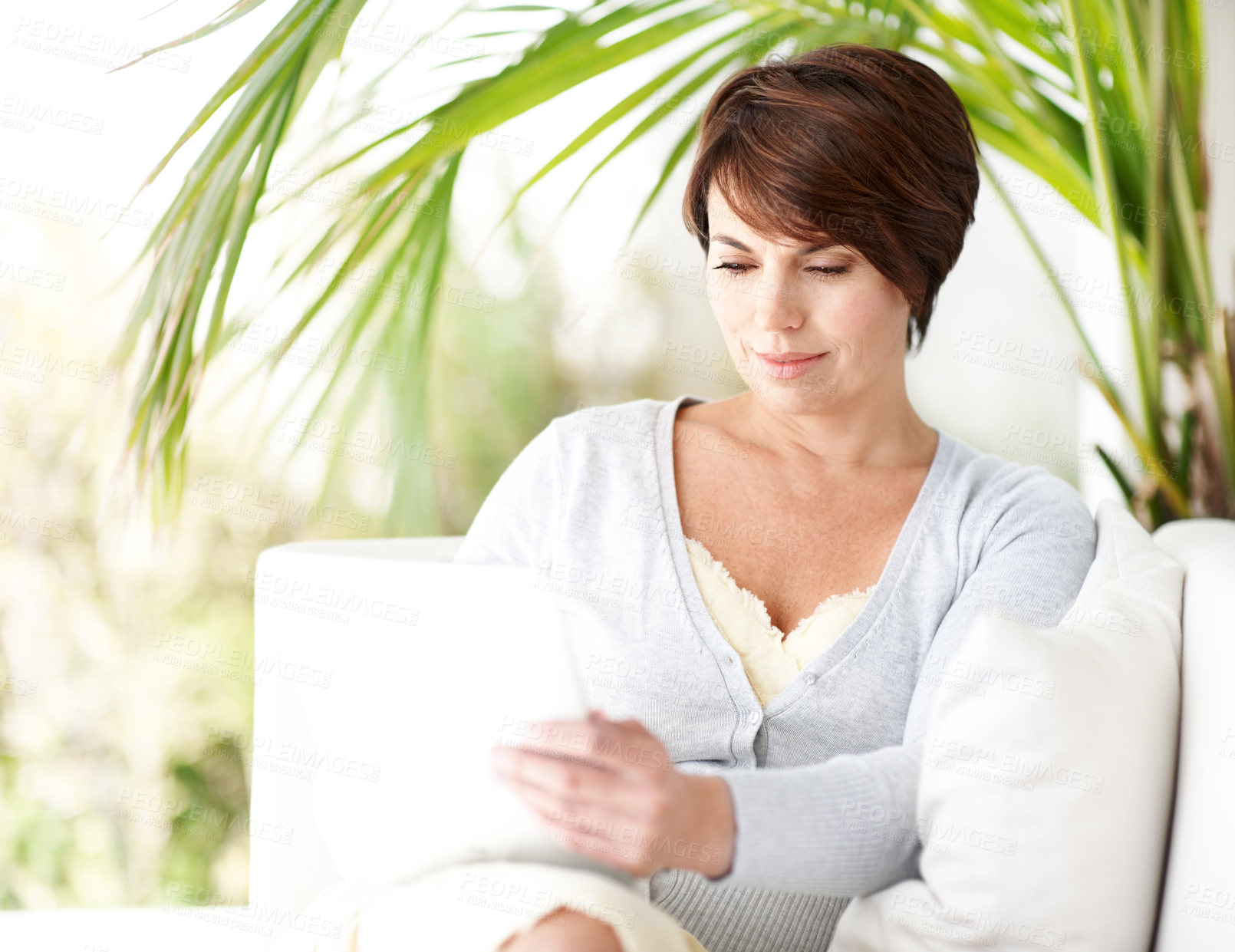Buy stock photo Tablet, relax and woman at backyard, smile and reading news on internet with newsletter update. Tech, garden or happy person with blog, article information and social media post on sofa at patio