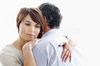 Buy stock photo Couple, hug and thinking with love in studio for comfort or commitment on a white background. Man, embrace and thoughtful woman with gentle touch or care for support, relationship or peace on space