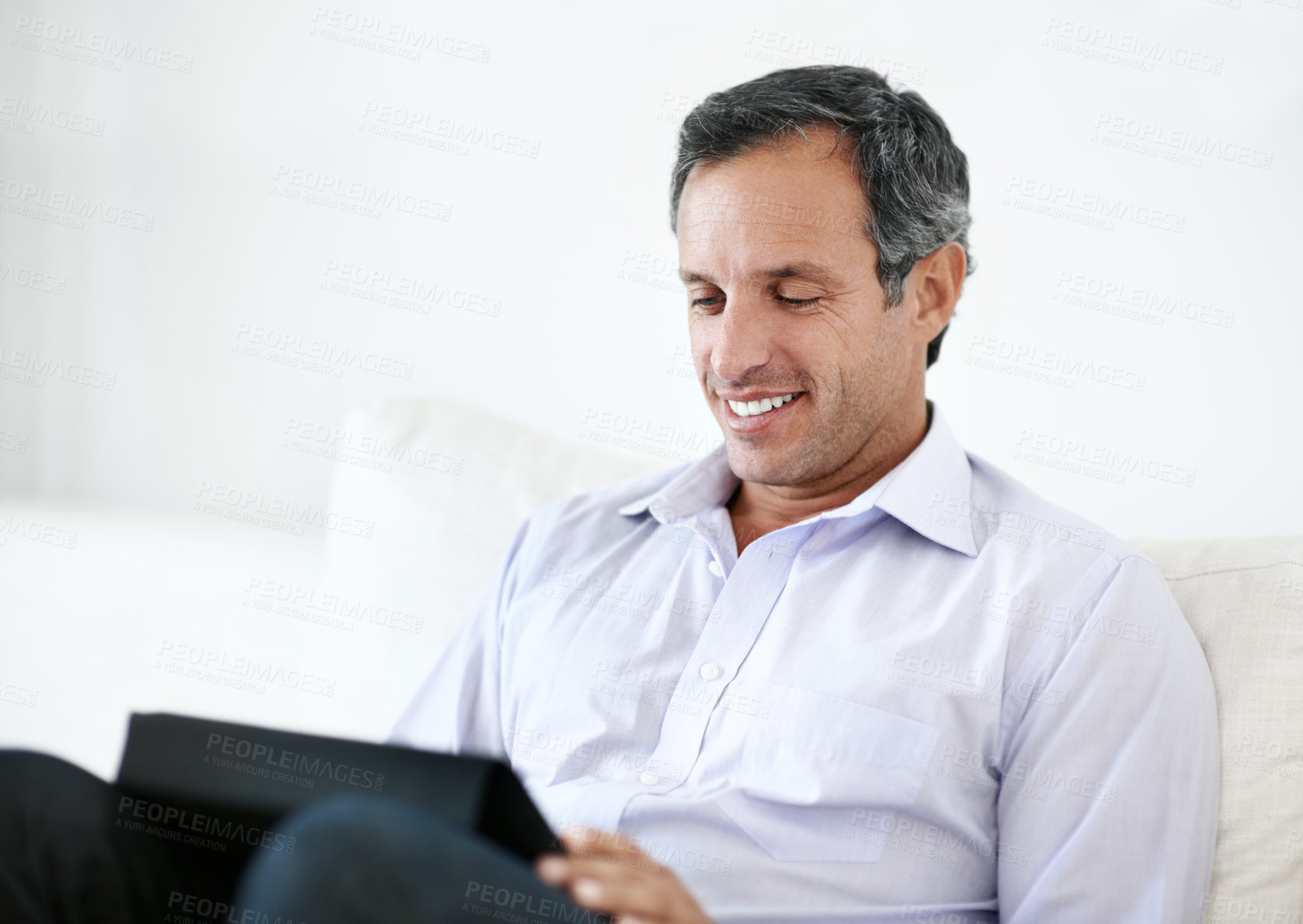 Buy stock photo Reading, remote work and man with tablet on sofa for insurance coverage, email or review. Technology, mature person and happy freelancer in home for policy benefits, claims report or risk assessment