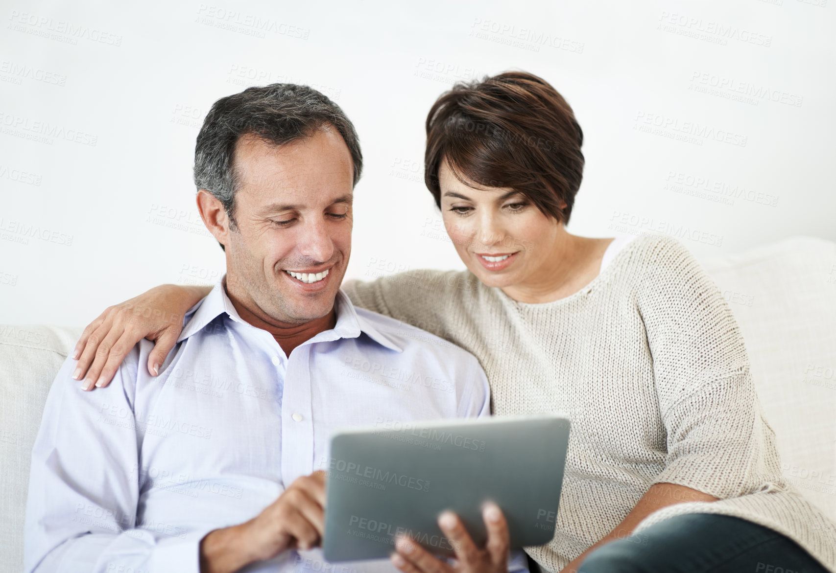 Buy stock photo Happy, couple and relax with tablet on sofa for website, online browsing or entertainment. Man, woman or chilling with smile or technology on couch for streaming app, subscription or network service