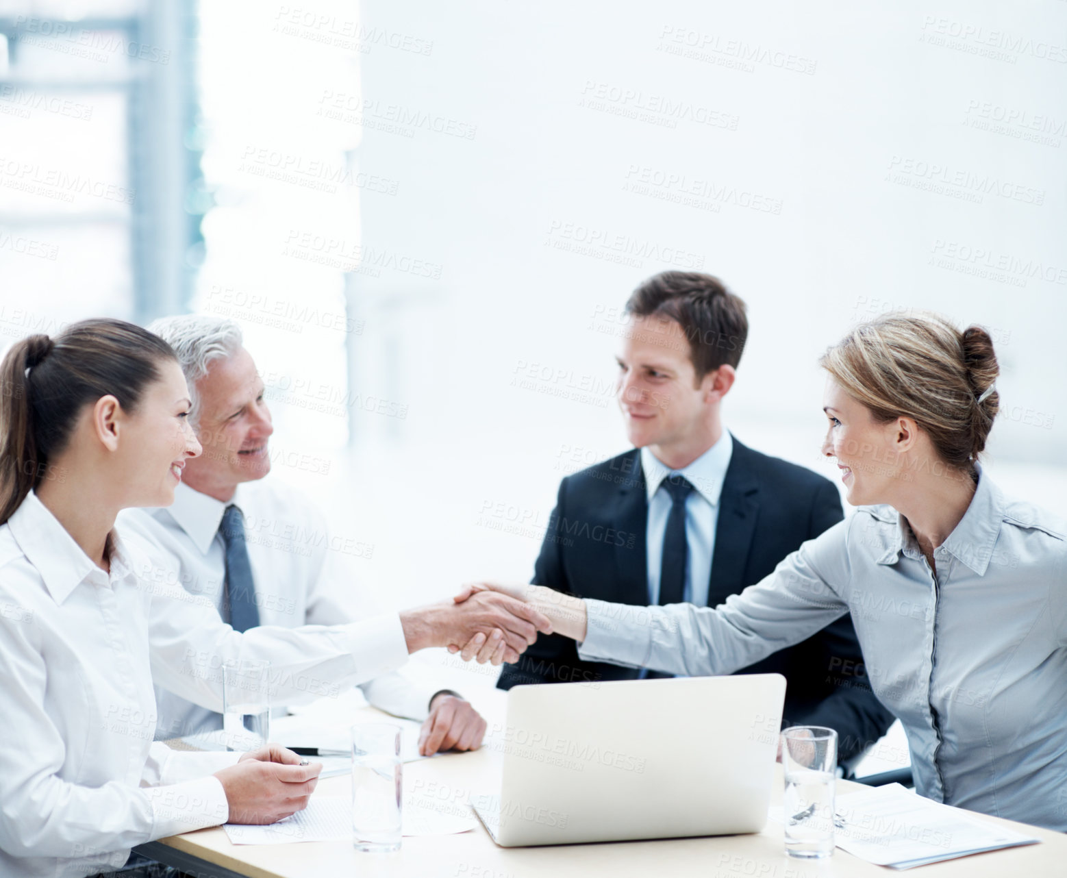 Buy stock photo Handshake, laptop and business people in office for deal, agreement or finance negotiation. Teamwork, meeting and financial advisor shaking hands with investor for partnership, contract or offer.