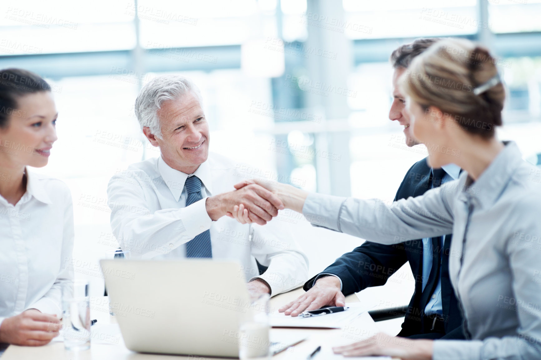 Buy stock photo Handshake, meeting and business people in office for partnership, agreement or finance negotiation. Laptop, discussion and financial advisor shaking hands with investor for deal, contract or offer.