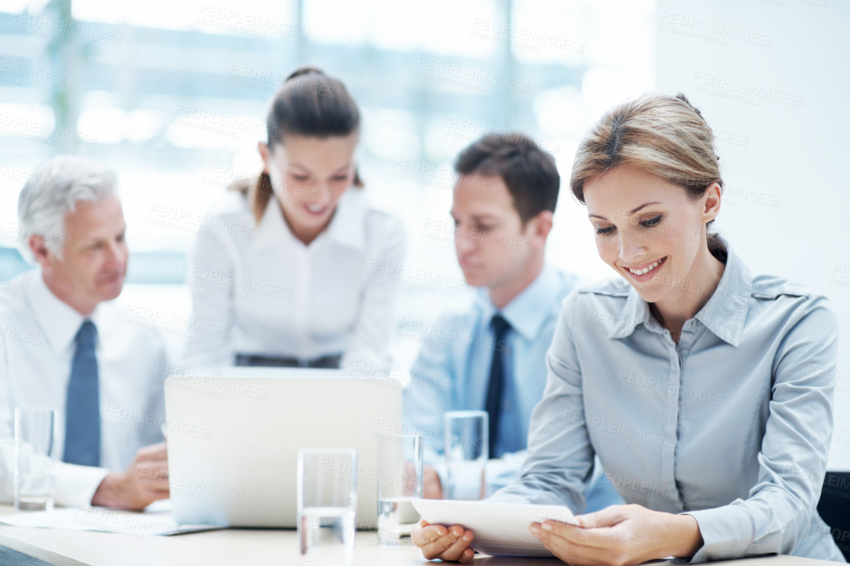 Buy stock photo Office, woman and reading document in meeting for financial compliance, report or review information. Paperwork, team and happy person with proposal, investment regulation and risk management