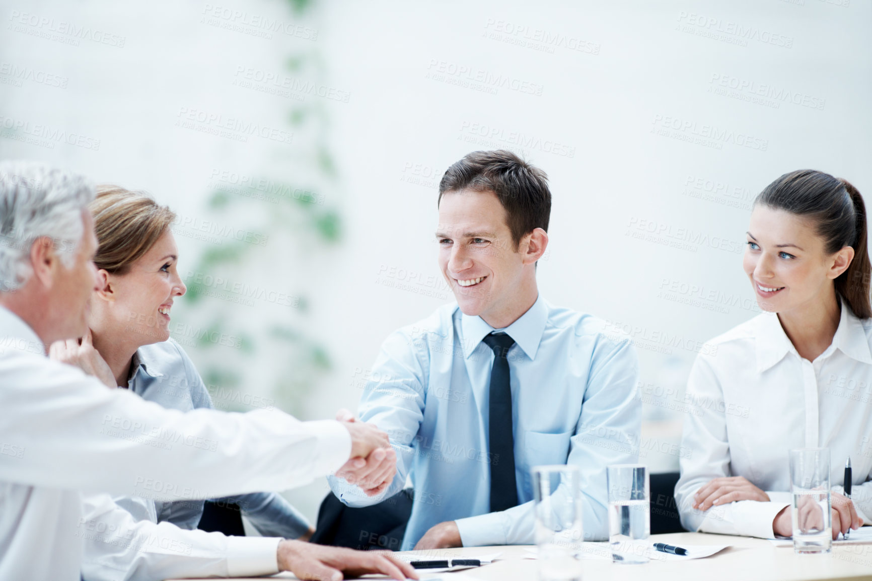 Buy stock photo Handshake, meeting and business people in office for contract, agreement or finance negotiation. Happy, discussion and financial advisor shaking hands with investor for partnership, deal or offer.