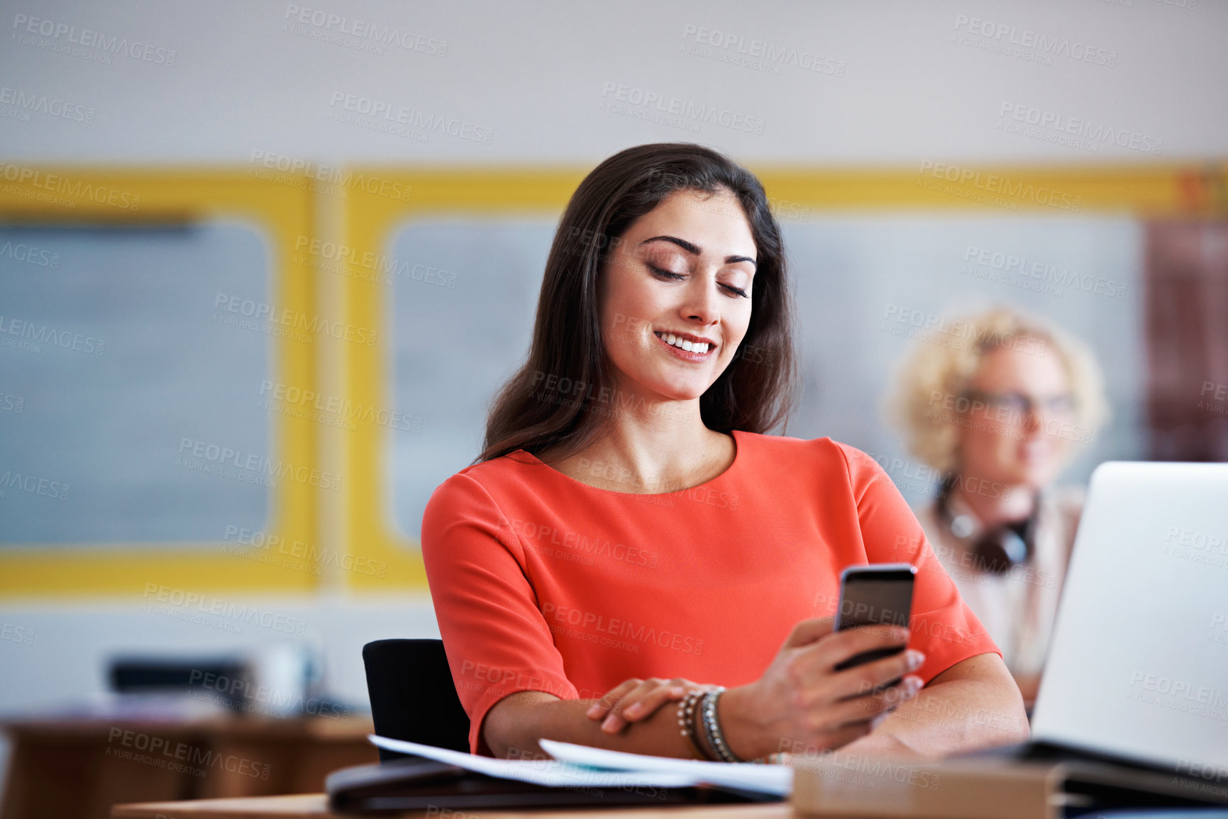 Buy stock photo Shot of an attractive businesswoman using a cellphone while at work at her deskj