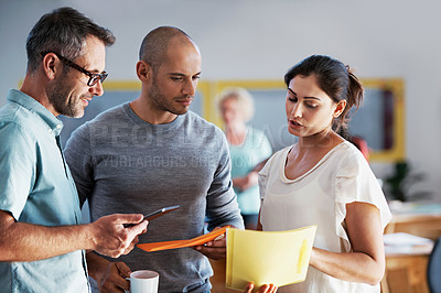 Buy stock photo Shot of a group of colleagues talking together while working in an office