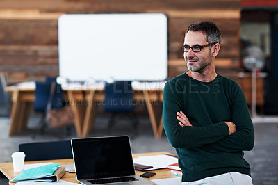 Buy stock photo Shot of a thoughtful-looking businessman standing in an office