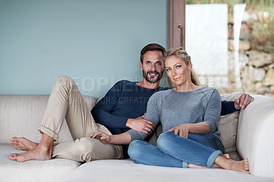 Buy stock photo Full length shot of a couple relaxing on their living room sofa