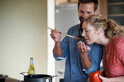 Buy stock photo Cropped shot of a couple cooking in the kitchen