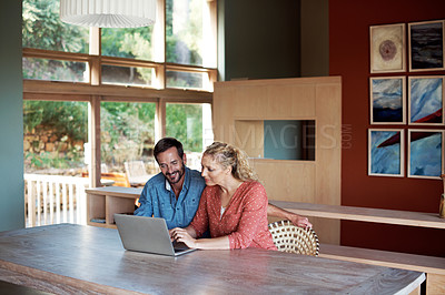 Buy stock photo Cropped shot of a couple using a laptop at home