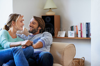 Buy stock photo Shot of a young couple relaxing on a sofa at home