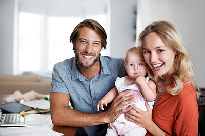 Buy stock photo Portrait of a young couple with their baby at home