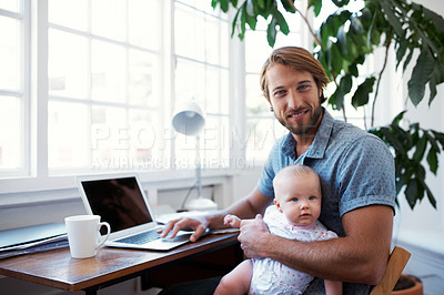 Buy stock photo Shot of a father using a laptop with his baby sitting on her lap