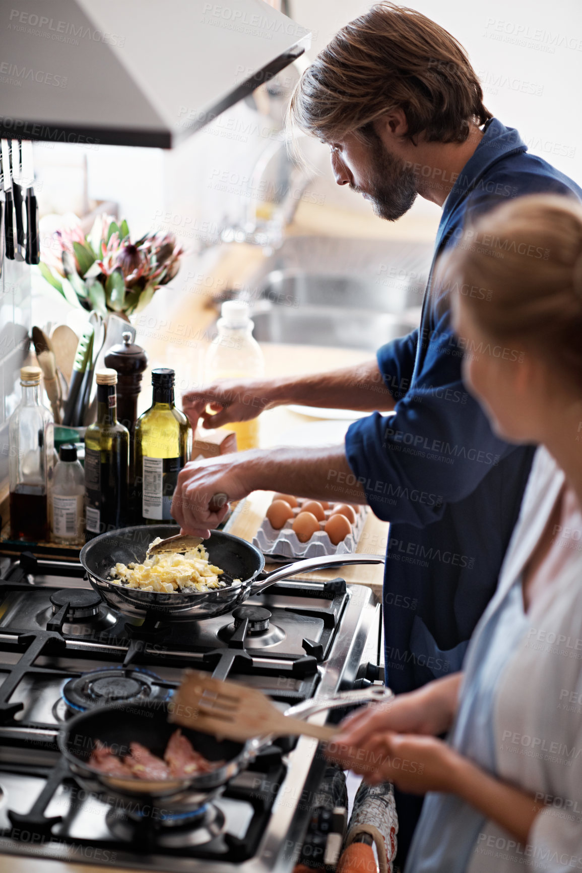 Buy stock photo Bacon, breakfast and eggs with couple in home together for bonding, culinary hobby or nutrition. Cooking, food and meal preparation with people in kitchen of apartment for diet, health or wellness