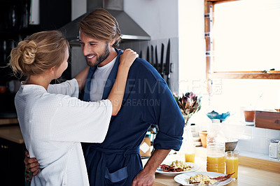 Buy stock photo Shot of a young couple sharing a moment together while cooking breakfast