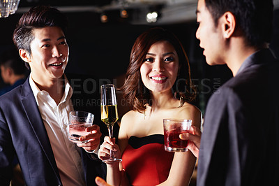 Buy stock photo Shot of a group of friends drinking together in a bar
